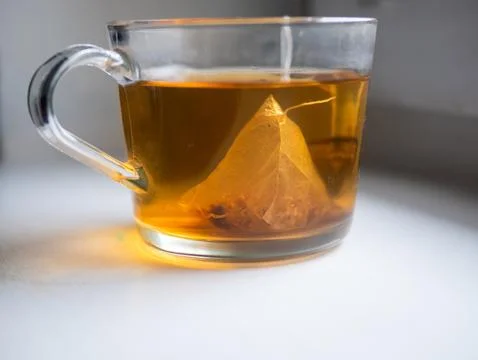 A cup of tea with a tea bag in it Stock Photos