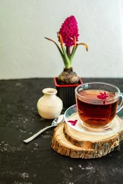 A cup of tea in a transparent cup with spring hyacinth flower on a black back Stock Photos