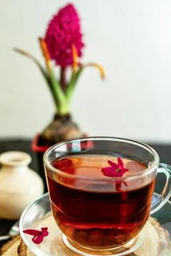 A cup of tea in a transparent cup with spring hyacinth flower on a black back Stock Photos