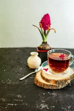 A cup of tea in a transparent cup with spring hyacinth flower on a black back Stock Photos