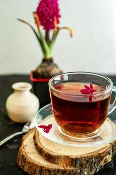 A cup of tea in a transparent cup with spring hyacinth flower on a black back Stock Photos