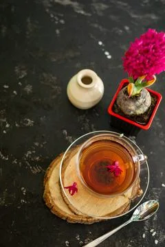 A cup of tea in a transparent cup with spring hyacinth flower on a black back Stock Photos