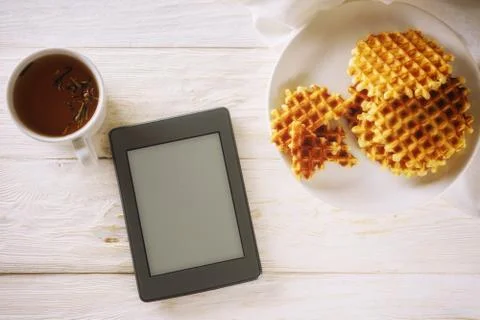 Cup of tea, waffle and ebook Fotos Stock