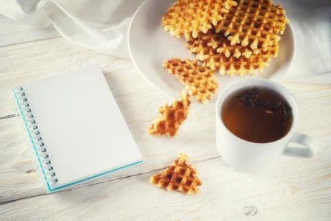 Cup of tea, waffle and notepad Stock Photos