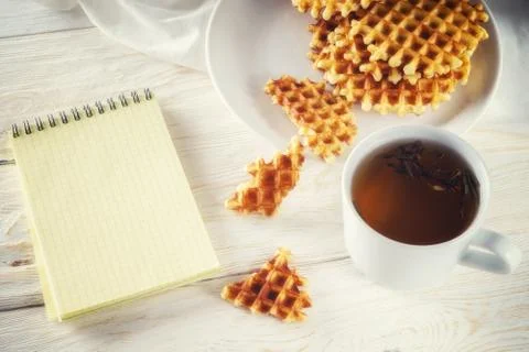 Cup of tea, waffle and notepad. Top view Stock Photos