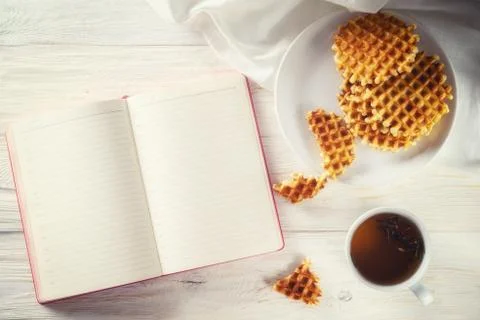 Cup of tea, waffle and notepad with space for text Stock Photos