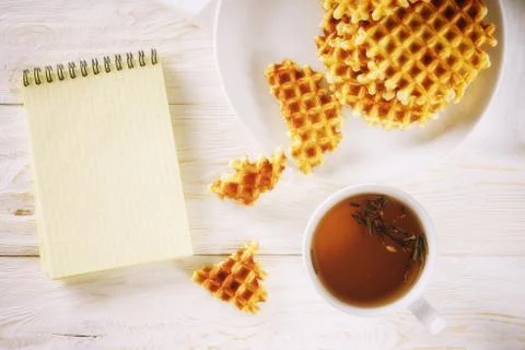 Cup of tea, waffle and notepad. Copyspace Stock Photos