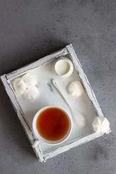 A cup of tea with white mini marshmallow. Stock Photos