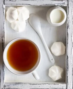 A cup of tea with white mini marshmallow. Stock Photos