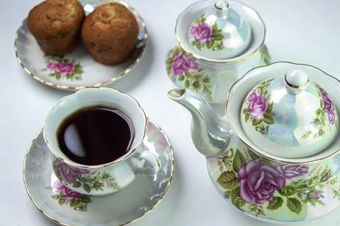 A cup of tea on a white tablecloth. Tea with muffins. Light breakfast. Stock Photos