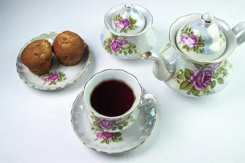 A cup of tea on a white tablecloth. Tea with muffins. Light breakfast. Stock Photos