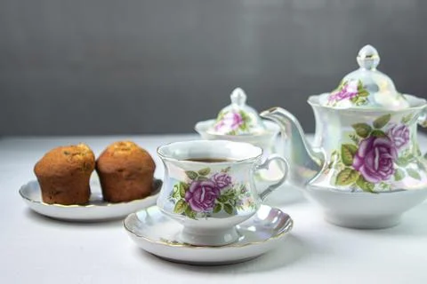 A cup of tea on a white tablecloth. Tea with muffins. Light breakfast. Stock Photos