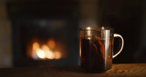 A Cup Of Tea on the wooden table, fireplace, steam Stock Footage 127638532