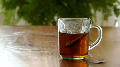 A cup of tea on a wooden table Stock Footage 230464374