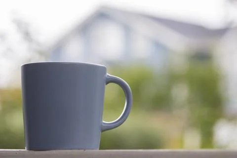 Cup of tee on house background Stock Photos