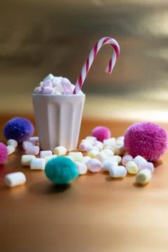 Cup with tiny colorful marshmallows and Christmas decoration Stock Photos