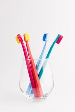 Cup with toothbrushes isolated on white background. Dental care Stock Photos