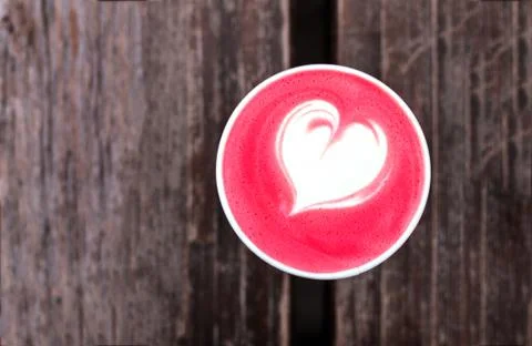 Cup of trendy beetroot latte on table. Stock Photos