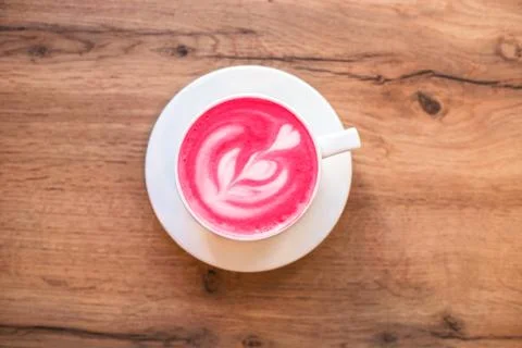 Cup of trendy beetroot latte on table. Stock Photos