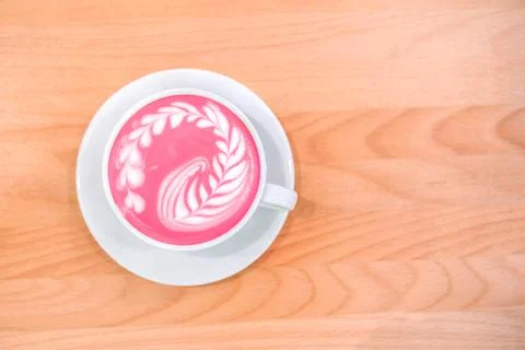 Cup of trendy beetroot latte on table. Stock Photos