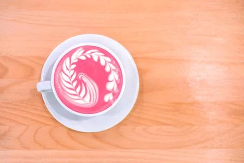 Cup of trendy beetroot latte on table. Stock Photos