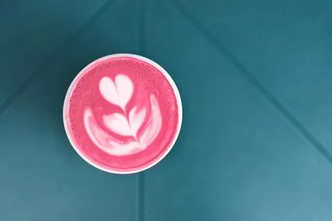 Cup of trendy beetroot latte on table. Stock Photos