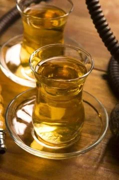 Cup of turkish tea and hookah served in traditional style Stock Photos