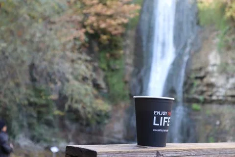Cup under the waterfall Stock Photos