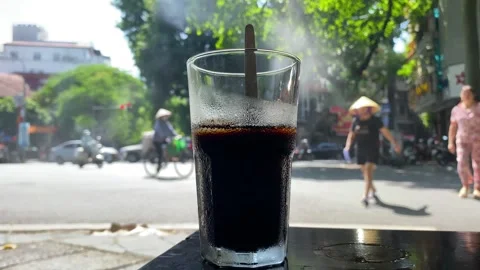 Cup of Vietnamese iced coffee, Ca Phe Den, in the capital Hanoi, Vietnam 4K Stock Footage 245059570