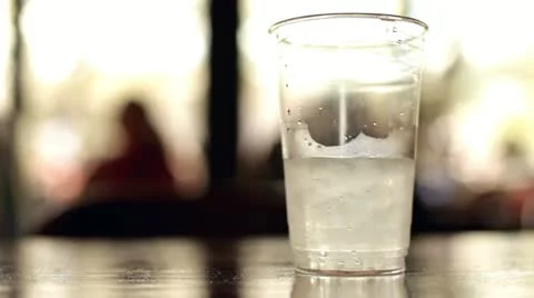 Cup of water with ice on table 스톡 동영상 10825316