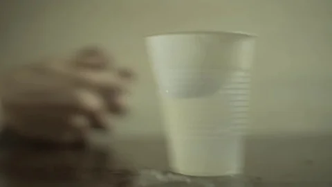 Cup Of Water On Table Shaky Cam Earthquake Guy Hands In Background Stock Footage 72875858
