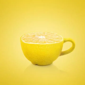 Cup on a yellow background. Cup with a texture of lemon. Creative. Abstract Stock Photos