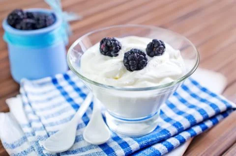 Cup of yogurt with blackberry Stock Photos
