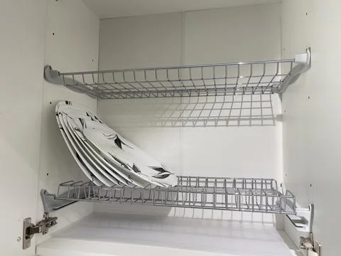 A cupboard with clean dishes in the kitchen. Stock Photos
