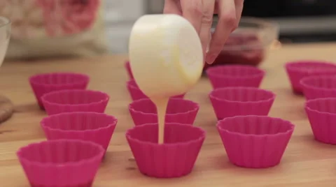 Cupcake batter being poured into cupcake form. 스톡 동영상 61367354