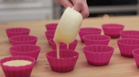 Cupcake batter being poured into cupcake form. 스톡 동영상 61367402