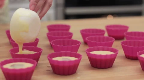 Cupcake batter being poured into cupcake form. 스톡 동영상 61367415