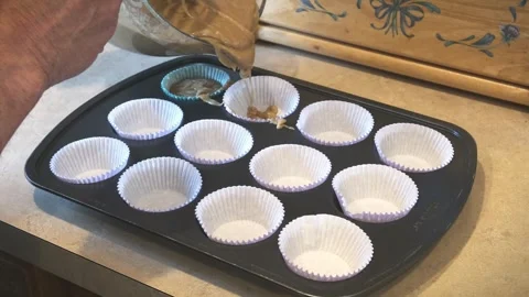 Cupcake batter poured into baking pan Stock Footage 283943888