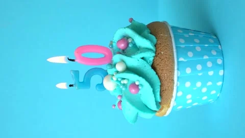 Cupcake with a burning candle number 50 Stock Footage 155807202