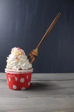 Cupcake cake with a fork on a black background with space for copyspace text. Stock Photos