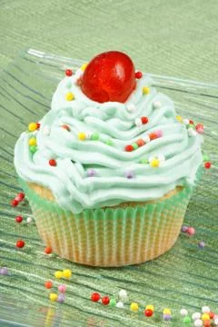Cupcake with candied cherry Stock Photos