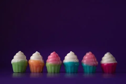 Cupcake candy on purple background Stock Photos