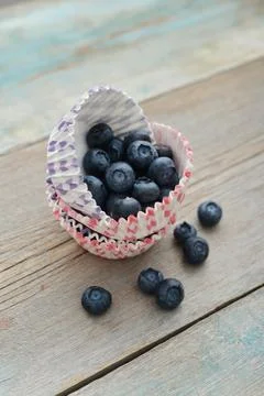 Cupcake cases with blueberry Stock Photos