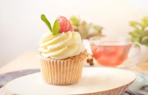 Cupcake with Cream and Raspberry Stock Photos