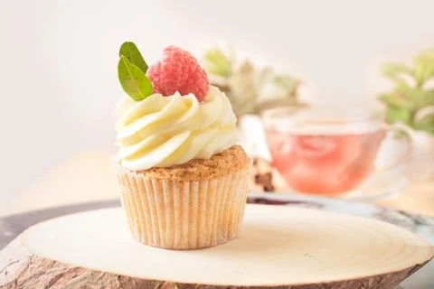 Cupcake with Cream and Raspberry Stock Photos