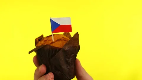 Cupcake with Czech flag on male palm against yellow background Stock Footage 161182553