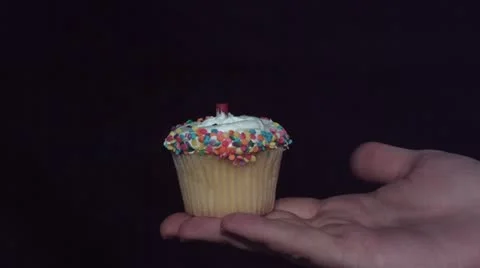 Cupcake exploding in hand Stock Footage