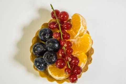 Cupcake with fresh bio fruit, orange, blueberry, red currant, photo view from Stock Photos