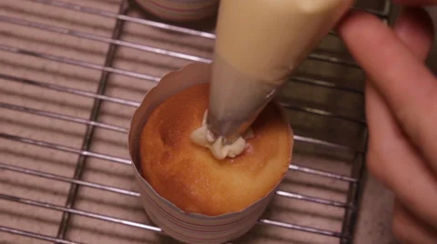 Cupcake getting icing applied Stock Footage 39842549