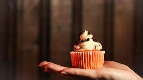 Cupcake in hand Stock Photos
